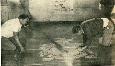 students cleaning crest on floor 