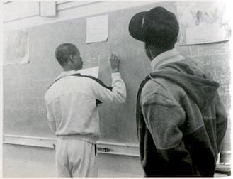student working at chalkboard 